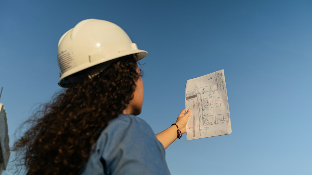 Profesional de obra civil revisando documentos de un proyecto de construcción en Colombia